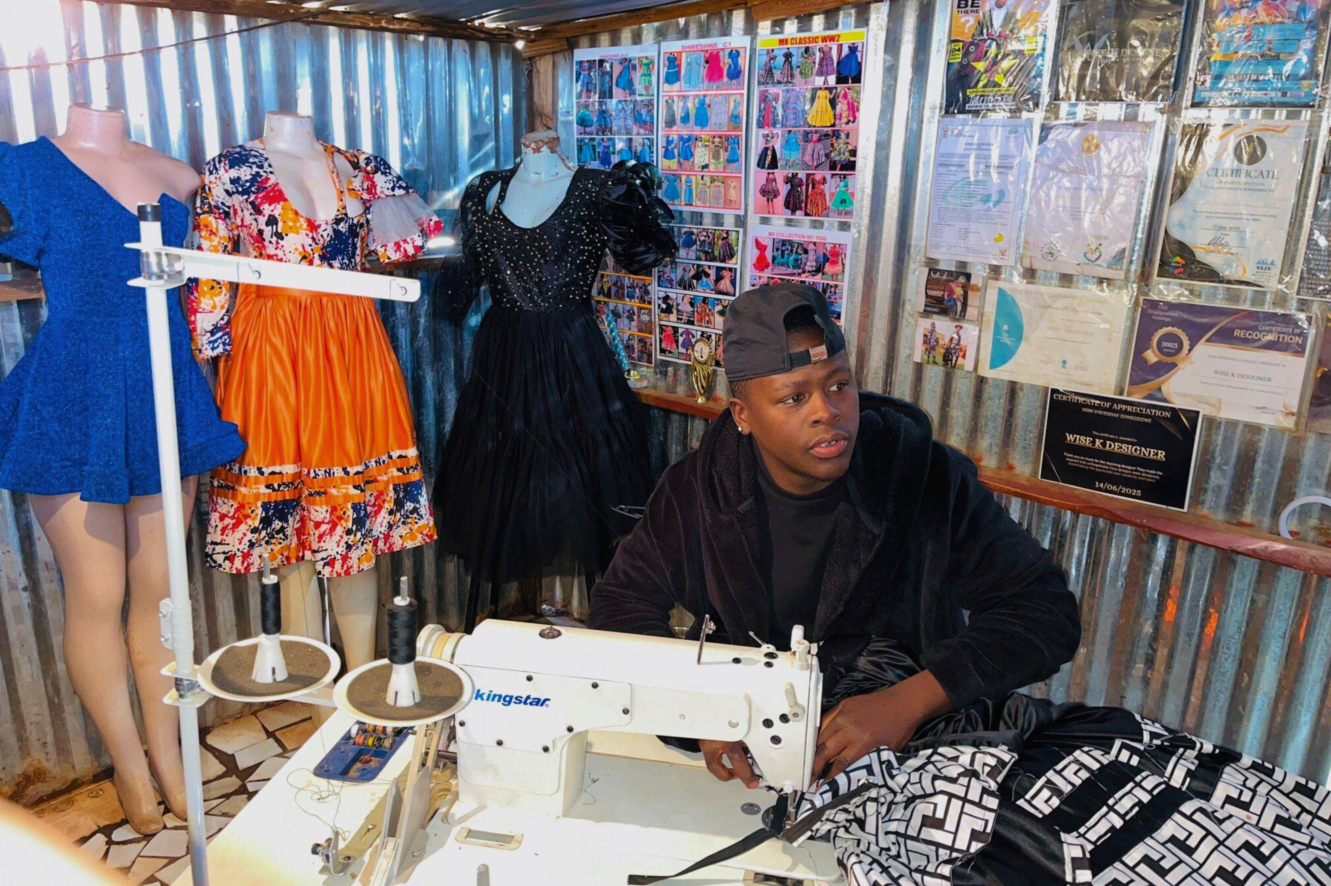 Fashion designer cutting fabric